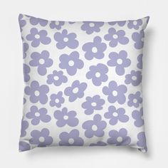 a purple and white pillow with small flowers on the front, against a white background