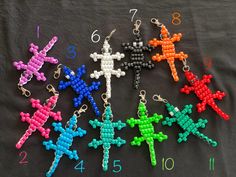 several different colored beads are arranged on a black surface, with numbers in the background