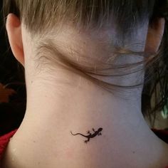 a small lizard tattoo on the neck