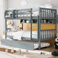 a child's bedroom with a bunk bed and toy panda bear on the floor