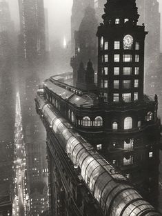 an aerial view of a train on the tracks in new york city at night time