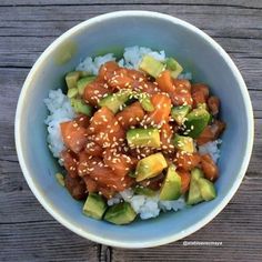 a blue bowl filled with rice, meat and veggies on top of it