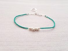 "Simple stacking bracelet featuring 11 tiny freeform sterling silver beads and an adjustable sliding clasp. I have many colors of string available, if you don't see a color you like listed, feel free to convo me! Bracelet adjusts from 6.25\" to 8.25\" with a small sliding bead, and also has a small spring ring clasp. The extra length of the clasp makes for a pretty dangle amongst your other bracelets, or all by itself! Find more adjustable bracelets here: https://www.etsy.com/shop/IDreamofJewelr Adjustable Nickel-free Sterling Silver Friendship Bracelets, Sterling Silver Adjustable Friendship Bracelets, Everyday Adjustable Sterling Silver Friendship Bracelets, Silver Bow, French Wire, Rose Gold Earrings, Turquoise Earrings, Bracelet Stack, Sterling Silver Bead