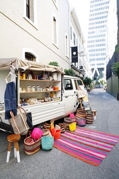 a van is parked on the side of the road with its door open and food in it