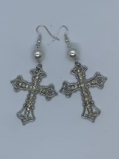 Beautiful earrings with silver crosses decorated with crystals and a pearl Length - 6 cm without hooks Gothic Cross Earrings, White Cross Jewelry For Party, Silver Cross Jewelry With Pearl Drop, Silver Metal Cross Pendant Earrings, Gothic White Dangle Jewelry, White Gothic Dangle Jewelry, Pierced Silver Pearl Earrings, Elegant White Cross Earrings, Cross Shaped Metal Earrings For Pierced Ears