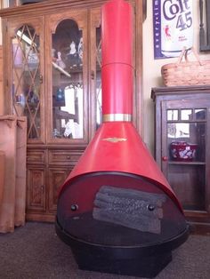 a large red stove sitting inside of a living room