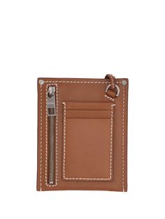 Expertly crafted from soft calf leather, the Jacquemus Le Porte Poche Meunier Logo Plaque Wallet is a versatile piece to carry your essentials in style. Its compact dimensions make it perfectly portable for on-the-go days yet fits credit cards, cash, and receipts with room to spare. Detailed with the signature Jacquemos brass plaque and adjustable chain strap allowing wear as a crossbody, this wallet ensures your outfit is Instagram-worthy wherever the day takes you. Lasting quality and chic des Brown Leather Wallet On Chain With Card Slots, Leather Wallet On Chain With Card Slots, Leather Bifold Clutch With Zipper Closure, Modern Brown Wallet With Interior Key Chain Holder, Modern Brown Wallets With Removable Pouch, Modern Brown Wallet With Removable Pouch, Designer Leather Clutch With Card Slots, Rectangular Leather Wallet On Chain With Card Slots, Luxury Clutch Wallet With Cell Phone Pocket