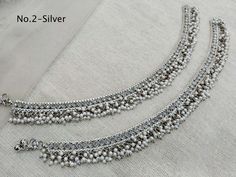 * Adjustable light weight Crystal pair of anklets/payal jewelry. *Comfortable & Light in weight. * 10 inches length. * Adjustable for anybody Ankle.   *No.1   *Width- 1 inches (Included drops)   *No.2   *Width- 1 inches ( Included drops)   *No.3   *Width- 1 inches ( Included drops)  *No.4   *Width- 1 inches ( Included drops) *No.5   *Width- 0.7 inches ( Included drops) *No.6   *Width- 0.7 inches ( Included drops) Silver Tilla Anklets For Puja, Festive Silver Anklets For Puja, Traditional Silver Anklets For Puja, Festive Silver Beads Toe Ring Anklets, Festive Toe Ring Anklets With Silver Beads, Silver Anklets For Puja, Silver Bollywood Anklets For Diwali, Silver Temple Jewelry Anklets For Wedding, Silver Bollywood Anklets For Festivals