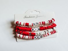 A stack of 5 bracelets.  Please note the mixed colors like red and white will be mixed in at random and may not be placed EXACTLY like this image as well as the the red bracelet.  Made to fit a standard wrist if you would like it to be bigger please request. Trendy White Stacked Bracelets, Trendy Red Stackable Jewelry, White Stacked Casual Bracelets, Casual White Stacked Bracelets, Red Adjustable Stacked Bracelets, Adjustable Stacked Red Bracelets, Red Stacked Beaded Bracelets For Gifts, Red Stacked Beaded Bracelets As Gift, Adjustable Red Stacked Beaded Bracelets