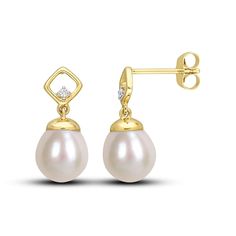 A luscious oval freshwater cultured pearl dangles from each of these splendid earrings. Styled in warm 10K yellow gold, a round diamond sparkles on each setting for a subtle hint of sparkle. The earrings secure with friction backs. 14k Gold Classic Diamond Earrings With Elegant Design, Classic 14k Gold Diamond Earrings With Elegant Design, Yellow Gold Diamond Earrings With Pearl Drop, Elegant Pear-shaped Diamond Earrings For Pierced Ears, Gold Pear Shaped Diamond Pearl Earrings, Classic Diamond Drop Pearl Earrings, Gold Pear-shaped Diamond Pearl Earrings, Fine Jewelry Pear-shaped Diamond Earrings With Pearl Drop, Timeless Oval Pearl Drop Earrings