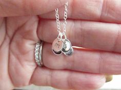 "\"Sterling Silver Tiny Treasure 3\" This necklace features very petite personalized charms; Swarovski birthstone crystal(s), and tiny sterling silver oval tag charm(s) hand metal stamped with your choice of initial. They are attached to a fine sterling silver chain which has a lobster clasp closure. Both charms are included; if you need 2 initials and 2 birthstones, select \"2\" from the option box, \"3\" for 3 initials and 3 birthstones, and so on. A lovely personalized gift for those who pref Hand Stamped Sterling Silver Oval Pendant, Sterling Silver Hand Stamped Oval Pendant Jewelry, Dainty Oval Sterling Silver Charm Necklaces, Oval Silver Sterling Silver Charm Necklaces, Silver Sterling Oval Charm Necklaces, Silver Oval Sterling Silver Charm Necklace, Personalized Oval Sterling Silver Charm Necklaces, Personalized Oval Sterling Silver Charm Necklace, Silver Hand Stamped Oval Pendant Jewelry