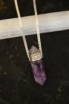 This large Amethyst Crystal necklace is the one you've been dreaming of. This double-terminated Amethyst necklace holds extra power and strength with two points on either end. Amethyst, known as the stone of spiritual wisdom, is believed to enhance intuition, calm the mind, and foster a sense of inner peace. Wearing this beauty not only elevates your style but invites the harmonizing influence of Amethyst into your daily life. Double-terminated Amethyst gemstone pendant approximately 3" in lengt Spiritual Amethyst Pendant Necklace, Lavender Spiritual Crystal Pendant Necklace, Lavender Pendant Crystal Necklace For Spiritual Use, Lavender Spiritual Pendant Necklace, Purple Amethyst Amulet Necklaces, Spiritual Amethyst Gemstone Necklaces, Amethyst Amulet Necklace For Meditation, Amethyst Pendant Necklace For Healing, Purple Amethyst Amulet Necklace