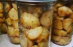 three jars filled with potatoes sitting on top of a table