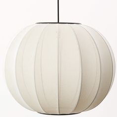 a large white ball hanging from a ceiling