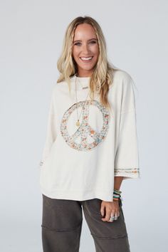 Comfy and cozy, yet with a style that's ideal all year round is the Beatrix Pullover! This will quickly become your go-to because it features: Comfortable and cozy, mineral-washed, terry knit fabric Loose and oversized pullover silhouette Classic crew neckline Dropped shoulders with loose 3/4 length sleeves Contrast floral printed fabric along the edges and center-front peace sign Ribbed trim along the neckline and bottom edges Raw edges and side slits for added boho style and comfort Wear this Cozy Cotton Leisure Tops, Fall Stonewashed Relaxed Fit Tops, Fall Stonewashed Relaxed Fit Sweatshirt, Stonewashed Relaxed Fit Sweatshirt For Fall, Relaxed Fit Stonewashed Tops For Fall, Comfortable Acid Wash Top For Loungewear, Acid Wash Tops For Fall Loungewear, Cozy Sweatshirt For Spring Leisure, Cozy Spring Sweatshirt For Leisure