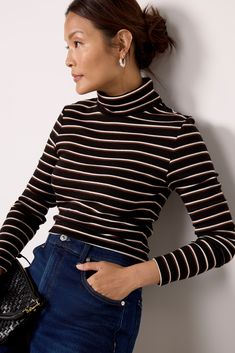 A must-have wardrobe essential, this striped turtleneck tee by Sanctuary is crafted in soft rib knit fabric and features a fitted silhouette with long sleeves. It's perfect for wearing alone with jeans, or layering with your favorite vest, shacket, or blazer. Striped Stretch Turtleneck Top, Ribbed Striped Tops For Workwear, Striped Ribbed Top For Workwear, Striped Long Sleeve Casual Turtleneck, Striped Long Sleeve Turtleneck For Winter, Casual Striped Turtleneck For Fall, Rib Knit Fabric, Feminine Blouses, Striped Turtleneck