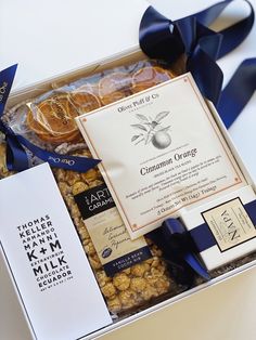 a box filled with different types of food and snacks on top of a white table