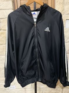 Adidas Men’s Vintage Black Hooded Windbreaker Logo 3 White Stripes Size XL. (R4) Jacket is in great, vintage condition. No odors. No rips or tears. Elastic cuffs and hem. Full zip. Hooded and logo on back. P2P measures 23 inches and back of neck to hem is 27 inches. Shipped USPS First Class Please view photos and feel free to ask questions. Vintage Black Windbreaker For Outdoor Activities, Adidas Hooded Long Sleeve Jacket For Streetwear, Adidas Black Windbreaker With Logo, Black Adidas Windbreaker For Winter, Adidas Casual Hooded Jacket For Streetwear, Urban Adidas Black Windbreaker, Casual Adidas Hooded Jacket For Streetwear, Adidas Urban Black Windbreaker, Adidas Black Outerwear With Three Stripes Branding