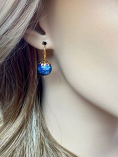 Beautiful vibrant and high-grade kyanite globe earrings. The 12 mm kyanite globes have a gorgeous deep vibrant blue color. The globes attached to beautiful 14K gold-filled flower caps as they dangle from the vermeil on sterling ear wires. These are elegant and perfect earrings to go with any outfit. A pair of fine gemstone essentials. *Ball size (diameter): 12 mm *Metal: vermeil on sterling *Earrings drop length (ear wires including the crystals): 25mm / 1 inch Solid gold, silver, and gemstones Round Lapis Lazuli Gemstone Earrings, Handmade Round Lapis Lazuli Earrings, Blue Lapis Lazuli Jewelry With Ear Wire, Blue Lapis Lazuli Earrings For Formal Occasions, Blue Lapis Lazuli Earrings, Pierced Lapis Lazuli Round Jewelry, Royal Blue Lapis Lazuli Round Jewelry, Nickel-free Sapphire Round Earrings, Formal Blue Lapis Lazuli Earrings