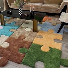 a living room with a couch, coffee table and puzzle pieces rug on the floor