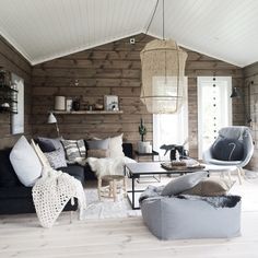 a living room filled with furniture and wooden walls