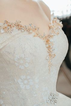 the back of a wedding dress with beading on it