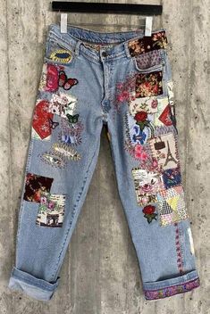 a pair of jeans with patches and flowers on them