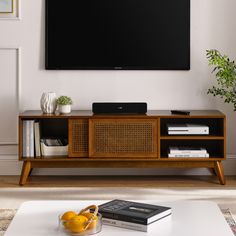 a flat screen tv mounted to the side of a wooden entertainment center in a living room