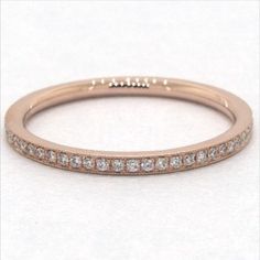 Crafted in 14K rose gold, this single row diamond band with delicate milgrain detail is chic and timeless. Wear this simply beautiful band on its own or stack with other rings for a fashion forward look. James Allen Ring Style: 81128R14 #weddingrings #weddingring #engagementrings #engagementring #marryme #proposal #isaidyes #dreamwedding #propose #showmeyourrings #theknotrings #heputaringonit #imengaged #ido #diamondring #stackablerings #jamesallen #jamesallenrings #eternityband Heirloom Rose Gold Stackable Diamond Ring, Heirloom Stackable Rose Gold Diamond Ring, Classic Stackable Rose Gold Diamond Ring, Classic Rose Gold Half Eternity Stackable Rings, Classic Rose Gold Stackable Rings With Brilliant Cut, Classic Stackable Rings With Pave Setting, Rose Gold Diamond Band In Fine Jewelry Style, Fine Jewelry Rose Gold Stackable Rings With Pave Setting, Timeless Rose Gold Stackable Wedding Rings