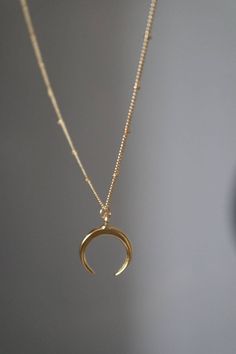 Dainty crescent moon necklace, perfect worn on its own or layered. Model wears 20 inches. --  18k gold filled chain -- 22k gold plated over brass metal moon charm -- Charm size 18x21mm About gold filled jewellery It's an actual layer of gold-pressure bonded to another metal. Gold filled is not to be confused with gold plating as filled literally has 100% more gold than gold plating. Gold filled is much more valuable and tarnish resistant. Nickel and lead free.  About Gold plated jewellery Gold plated over brass material doesn't last as long as real gold but people love gold plated because it is very affordable and yet beautiful. Plated material tarnishes at some point and can last longer with proper care. Please read Shop Policies/FAQ before buying. www.etsy.com/shop/aaliajewellery/policy Moon Choker, Gold Horns, Gold Moon Necklace, Choker Gold, Horn Necklace, Crescent Moon Necklace, Gold Moon, Necklace Dainty, Hoop Earrings Small