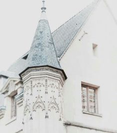 an old white building with a blue roof