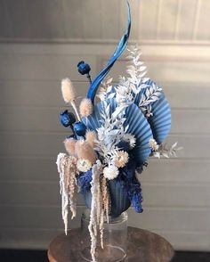 a vase filled with blue and white flowers