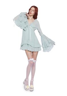 Be heavenly in this chiffon mini dress which has tiered bell sleeves, interlocking ribbon detailing, a ruffled trim, a plunging neckline, a cross charm on the front, and a tiered skirt. Chiffon Tiered Mini Dress With Ruffle Hem, Party Mini Dress With Ruffled Skirt And Sleeve, Chiffon Mini Dress With Ruffles, Feminine Tiered Chiffon Dress With Ruffles, Feminine Tiered Ruffle Chiffon Dress, Flowy Tiered Chiffon Dress With Ruffles, Tiered Chiffon Mini Dress With Ruffles, Fitted Chiffon Dress With Ruffle Hem And Tiered Shape, Feminine Bell Sleeve Ruffle Dress