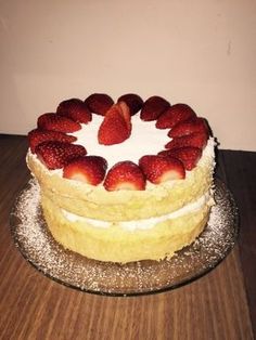 there is a cake with strawberries on it