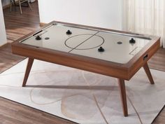 an air hockey table in the middle of a living room