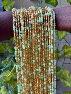 Traditional Ghanaian Thread Tie Waist Beads One size fits all Color: Teal and Gold Bohemian Green Beaded Bracelets With Gold Beads, Gold Bohemian Beads For Summer, Gold Beaded Bracelets For Summer Parties, Bohemian Summer Festival Waist Beads, Bohemian Green Waist Beads With Colorful Beads, Large Beads For Summer, Bohemian Green Waist Beads, Bohemian Beaded Waist Beads For Summer, Bohemian Gold Waist Beads For Festival