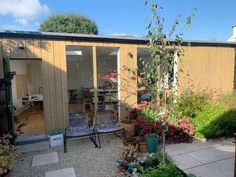 the back yard is full of plants and flowers