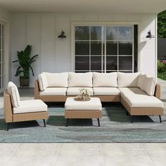 an outdoor living room with beige furniture