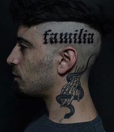 a man with a tattoo on his head has the word familia tattooed on it