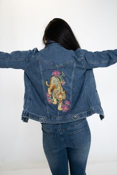 Beautifully embroidered denim jacket for women. Made of slightly faded blue denim, this jacket is fitted to enhance a woman's natural curves, and it hits at about the hips. Blue denim with an embroidered back, the embroidery design shows a tiger ready to pounce.  These jackets are very fitted, but they are very stretchy and they move with you, so you never feel restricted. If you would like a looser look, you need to order the next size. Please wash before first use. Machine wash delicate cycle, cold water. Tumble dry, delicate cycle, remove promptly. Embroidered Denim Jacket, Riders Jacket, A Tiger, Flowers Design, Jacket For Women, Embroidered Denim, Bras And Panties, Brilliant Colors, Betsey Johnson