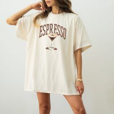 a woman wearing a white t - shirt with the word espresso printed on it