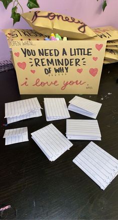 several pieces of paper sitting on top of a table next to a box with writing