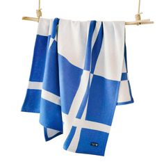 two blue and white towels hanging on a clothes line