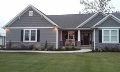 a gray house with white trim and black shutters