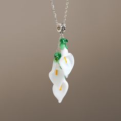 "This calla lily flower necklace are made of glass in lampwork technique. This unique and beautiful necklace have so many beautiful details, it bring freshness and elegance to every outfit! You will definitely get a lot of compliments on your new necklace, everybody loves it, and you'll love it too! Dimensions: total pendant height about 2 3/4 inch (70mm). Silver colored metal chain length is adjustable, 16\"-20\" inches (40-50cm). Materials: artist lampwork glass beads, metal fittings. Here's w Elegant Glass Flower Necklaces, Elegant Flower-shaped Glass Necklaces, White Flower Shaped Glass Jewelry, Elegant Flower Shaped Glass Necklaces, Elegant Glass Flower Necklace, Elegant White Glass Necklace, Elegant Glass Flower Pendant Necklace, Elegant Green Murano Glass Necklace, White Glass Wedding Necklaces