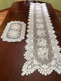 two white doily sitting on top of a wooden table