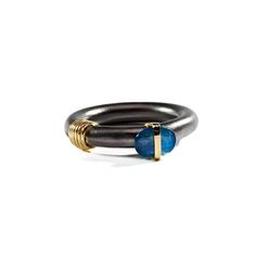 Simplistic yet sophisticated, this German Kabirski black-and-gold silver ring with unconventionally set oval blue sapphire is a perfect match for those who want to be different - every day. This piece is individually handcrafted  and might look slightly different from the picture. There will never be two completely identical pieces, so yours will always be one of a kind. Metal: 925 Silver Stones: Blue Sapphire Plating: Black Rhodium, Gold 18K German Kabirski, Blue Sapphire Ring, Forever Jewelry, Fine Art Jewelry, Jewelry Ring Box, Blue Sapphire Rings, Black Rhodium, Green Amethyst, Be Different