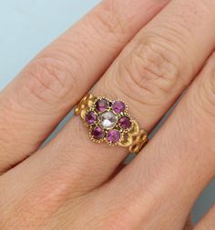 15CT YELLOW GOLD ROSE-CUT DIAMOND AND ALMANDINE GARNET CLUSTER RING. HALLMARK BIRMINGHAM 1866. ENGRAVED AND PATTERNED BAND.  UK size M 1/2 / US size 6 1/2.  At Wave Antiques we donate 1% of all sales made to ocean-protecting charities. We care deeply about the environment and with oceans covering 70% of the earth, we feel promoting sustainability and supporting ocean charities is essential to try and maintain the health of what exists beneath the waves  Please note all Wave Antiques pieces offer Victorian Gemstone Cluster Ring For Wedding, Victorian Gemstone Cluster Wedding Ring, Fine Jewelry Ruby Cluster Ring With Rose Cut Diamonds, Victorian Multi-stone Cluster Ring For Wedding, Gold Victorian Ruby Ring With Single Cut Diamonds, Antique Ruby Ring With Rose Cut Diamonds For Anniversary, Ruby Cluster Ring With Rose Cut Diamonds, Victorian Ruby Ring With Single Cut Diamonds For Wedding, Round Ruby Cluster Ring With Rose Cut Diamonds