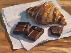 a painting of some chocolate and a croissant on a white plate next to it