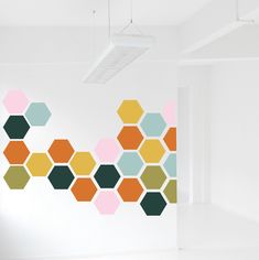 an empty room with hexagonal shapes painted on the wall